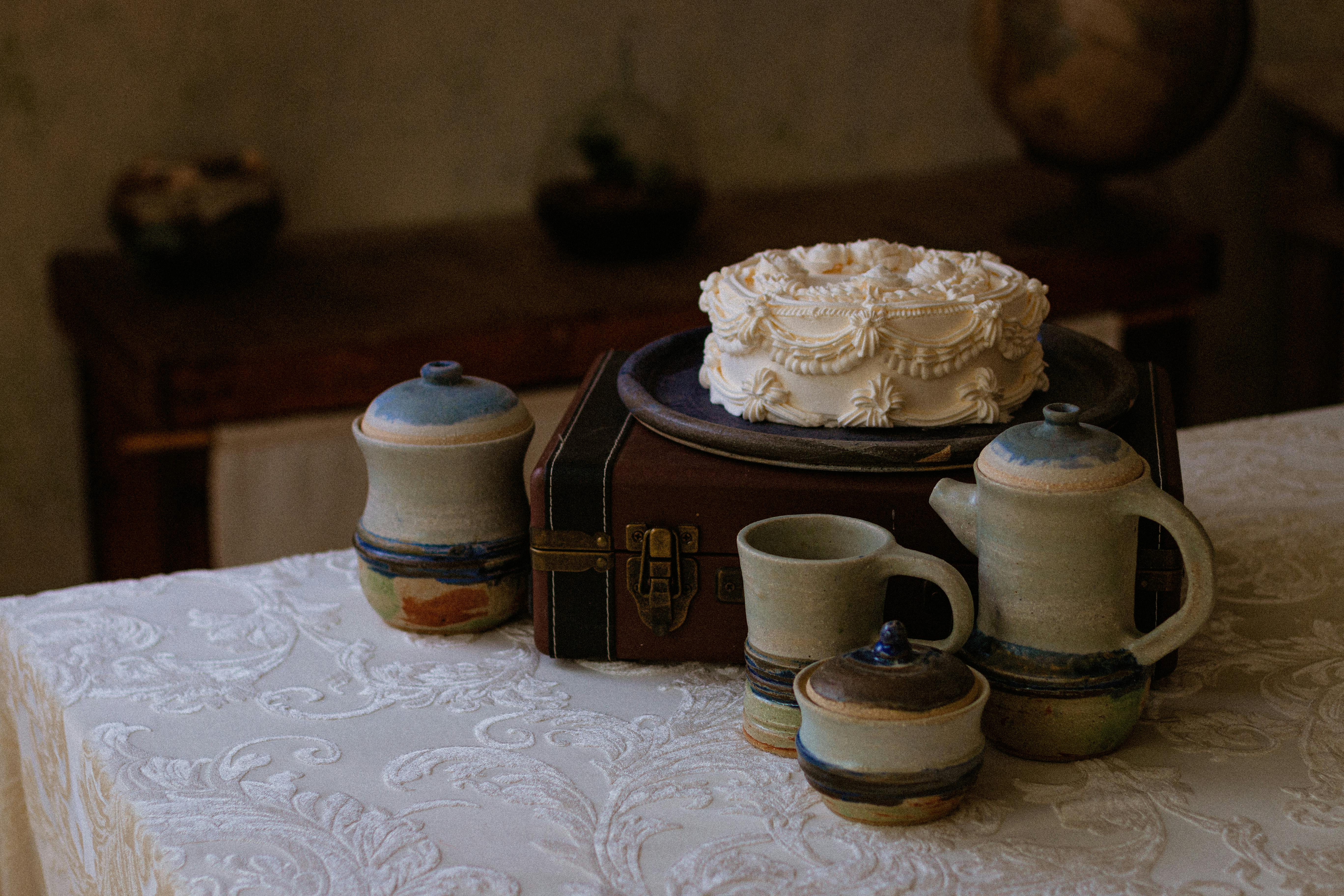 Rustic handcrafted pottery set with a decorated cake on a vintage table setting, Chiapas, Mexico.