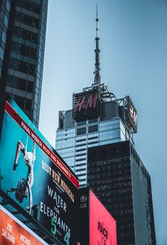 Photo by Louis Dynamic view of Times Square with towering billboards and skyscrapers in New York City.