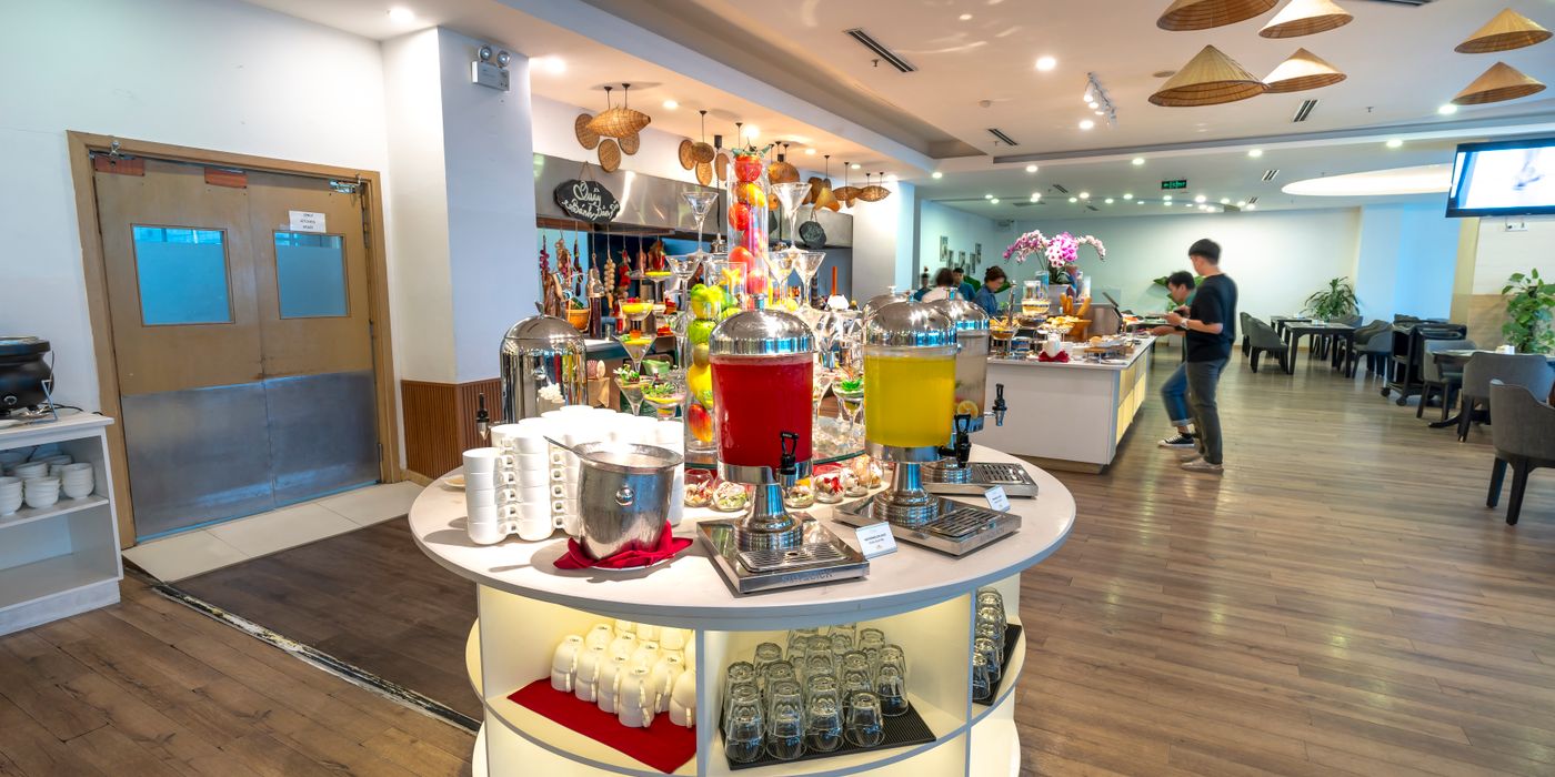 Spacious hotel buffet area with a variety of drinks and seating