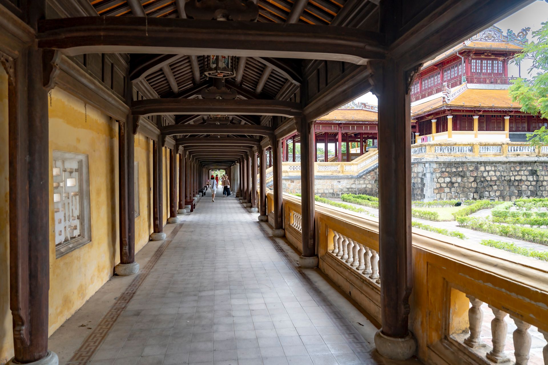 Interior view of a historic wooden corridor at the Imperial City in Hue, Vietnam.