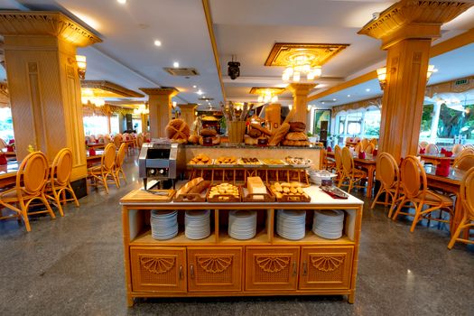 Lavish breakfast buffet arrangement in a luxurious restaurant with artisan breads and pastries.