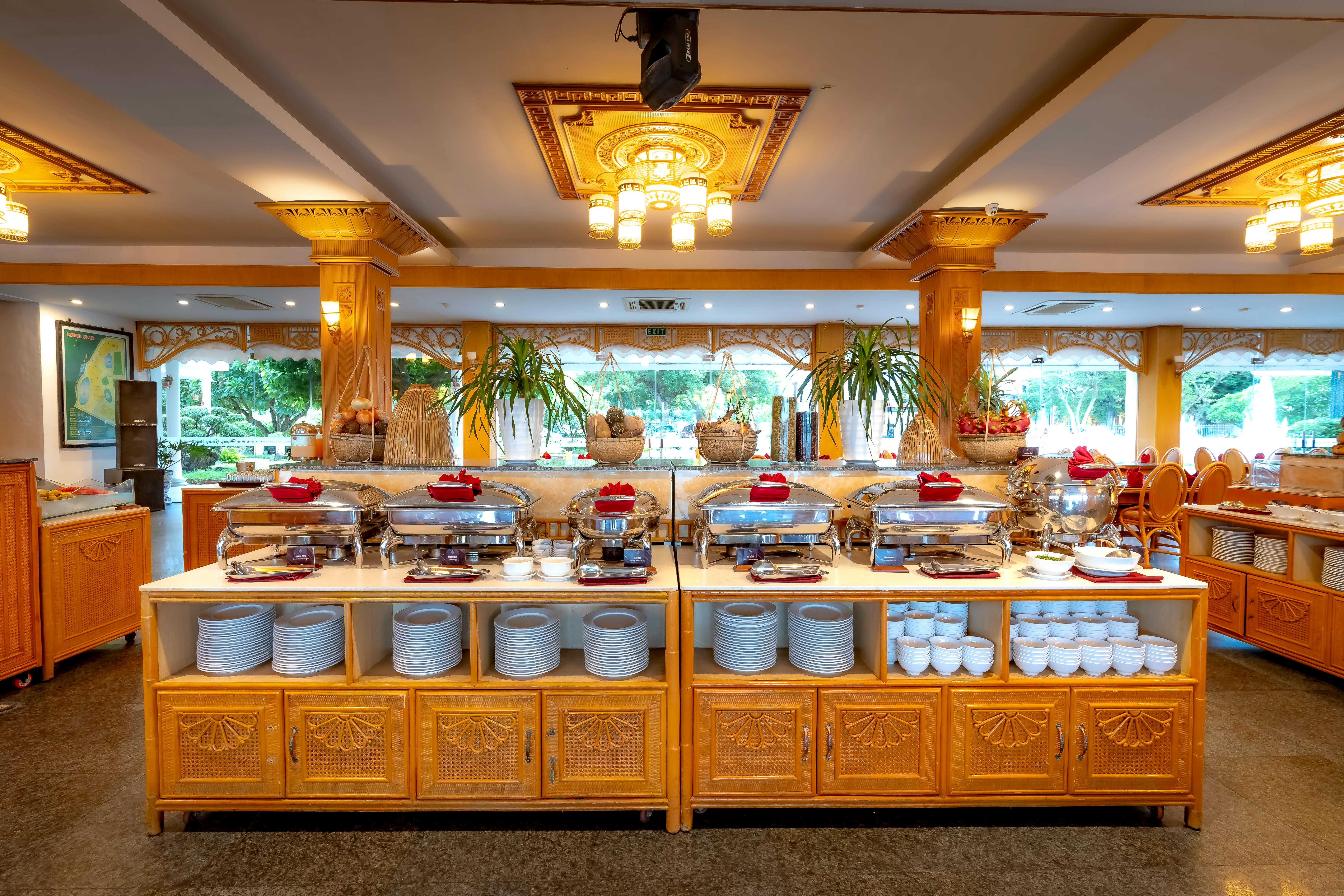 Professional catering setup showing neat buffet presentation with chafing dishes, linens, and decorative elements - Event Catering Near Me