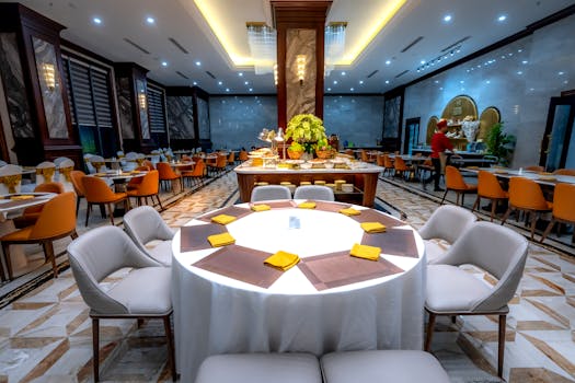 Spacious dining area with elegant decor, modern lighting, and neatly arranged tables for dining.