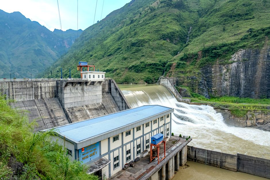 A modern modular dam assembly site with cranes and precast components