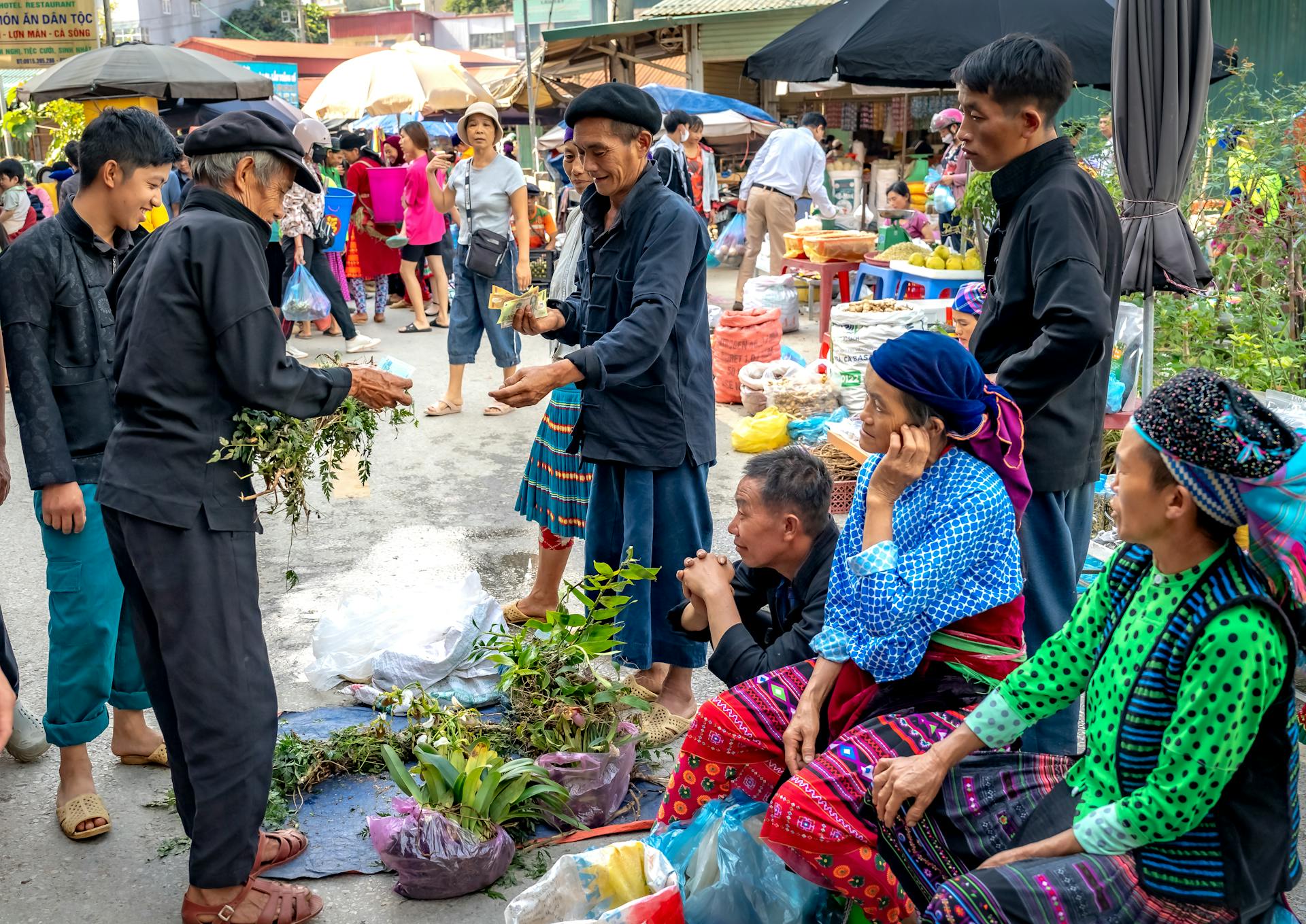 Vibrant scene of local vendors selling plants in a bustling market.