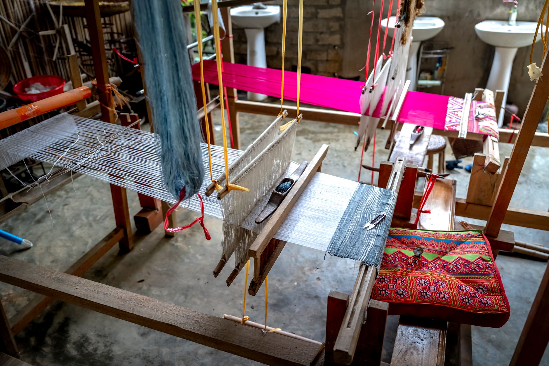 A vibrant traditional loom weaving colorful textiles in an artisan workshop setting.