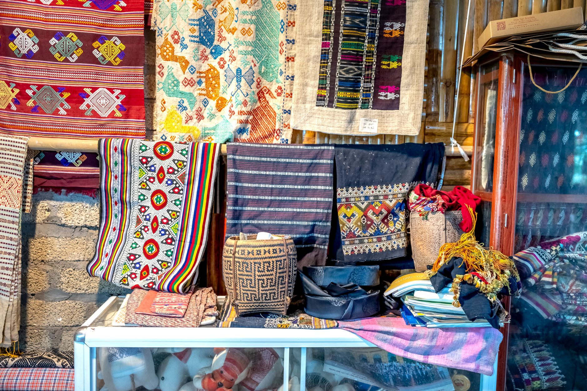 A vibrant collection of traditional textiles with intricate patterns and bold colors.