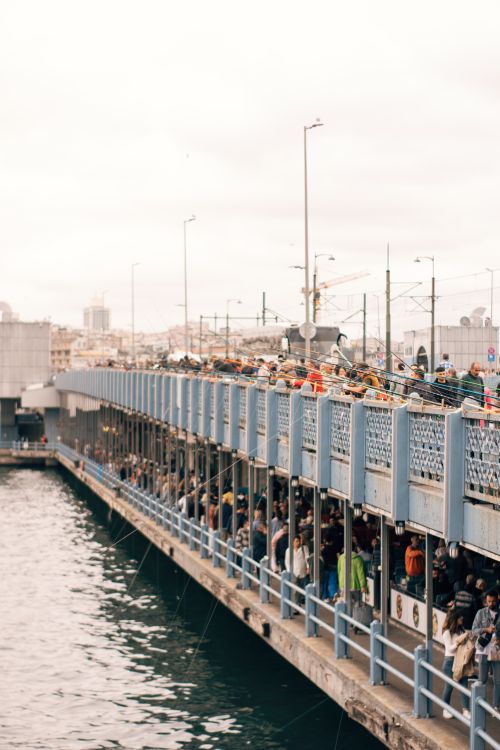 Free Crowded Galata Bridge filled with people overlooking the Bosphorus on a cloudy day. Stock Photo