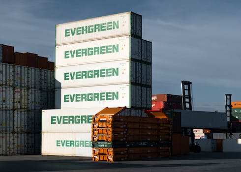 A stack of Evergreen cargo containers at Hamburg port, showcasing industrial logistics.