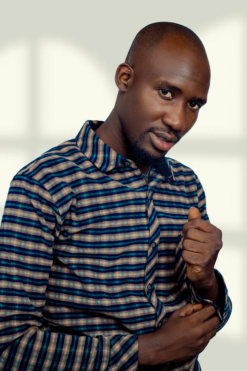 Free Confident man in striped shirt posing indoors. Stock Photo