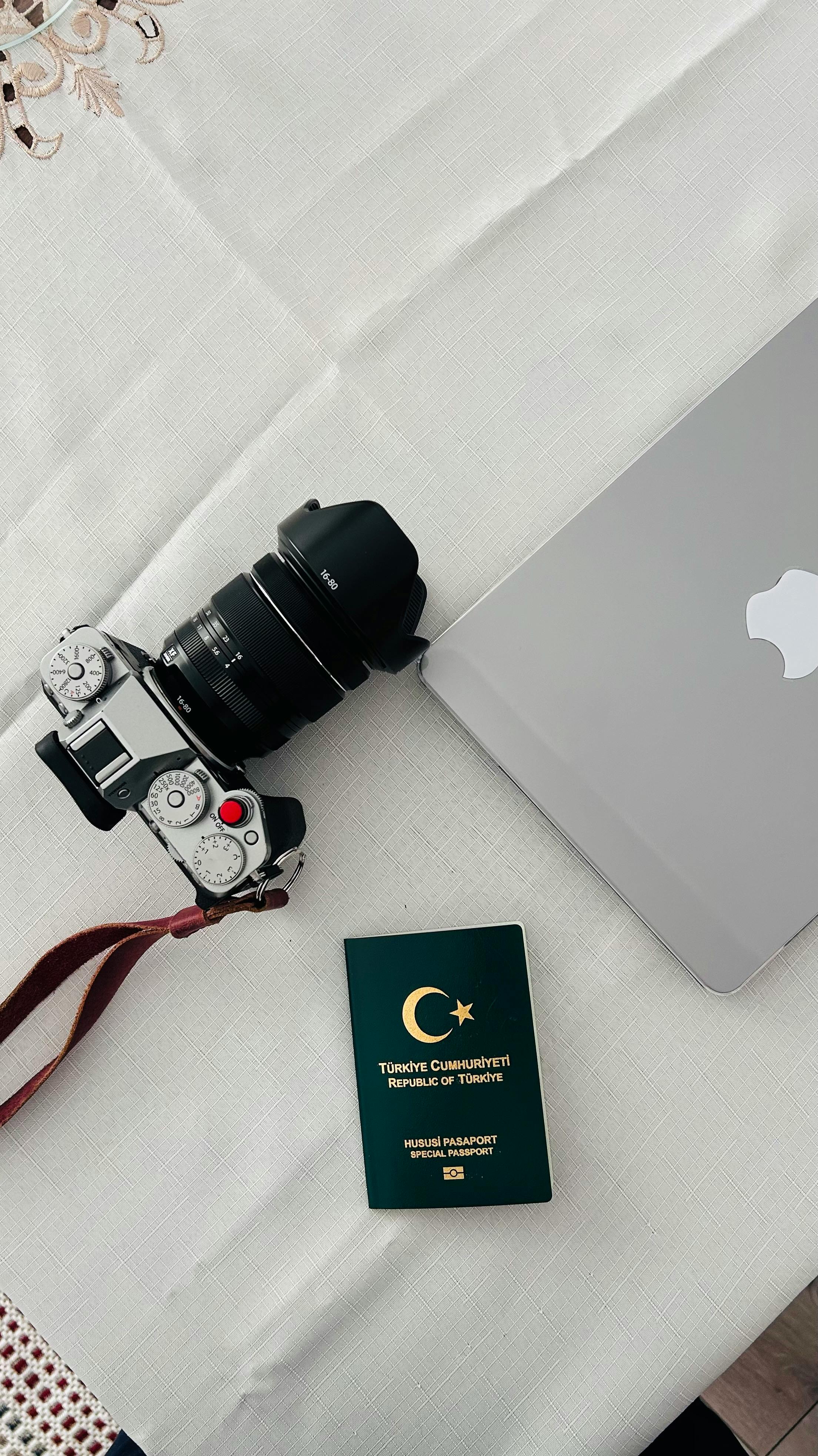 travel essentials with camera laptop and passport