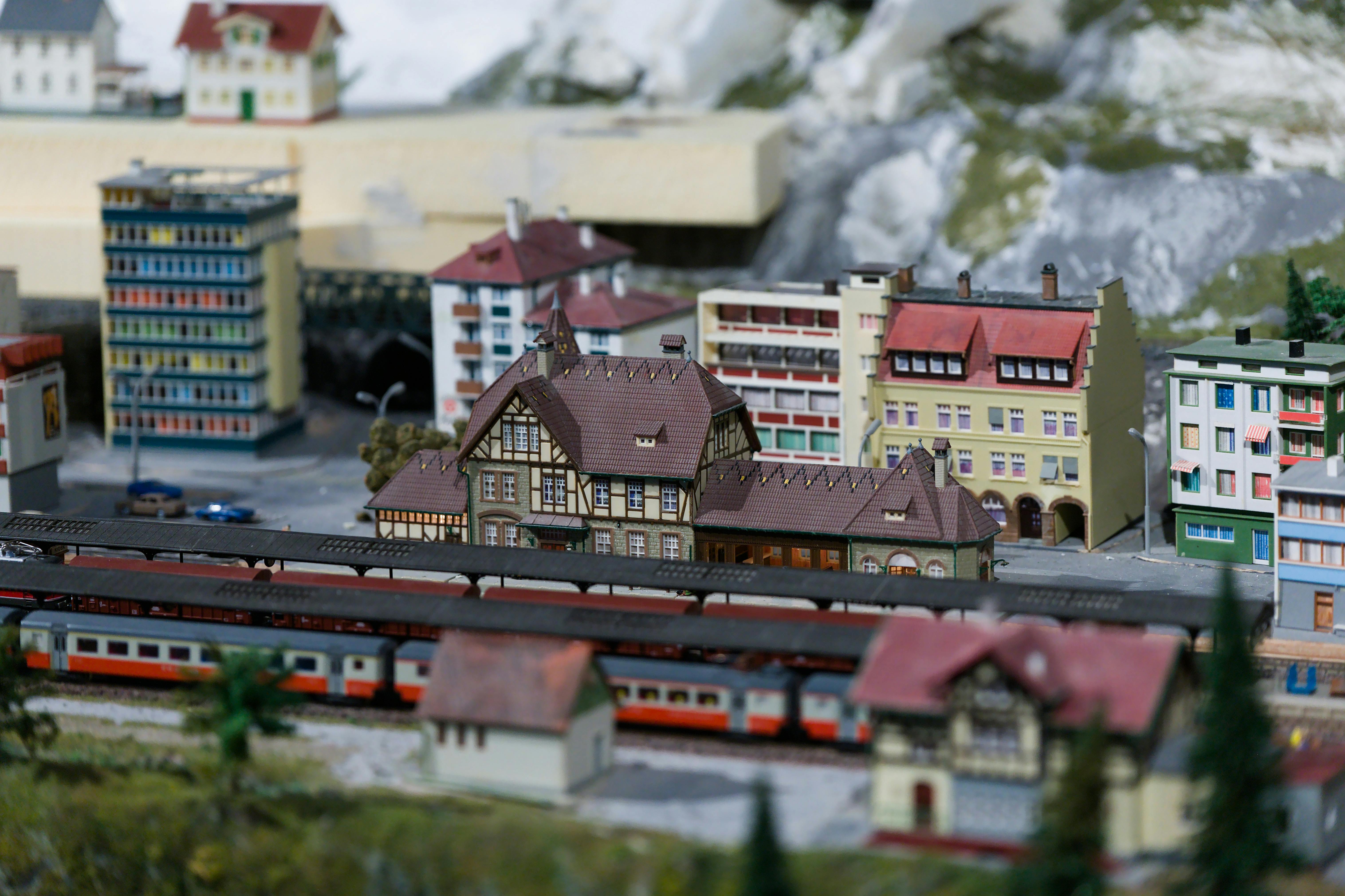 Free A detailed and intricate model of a European train station with surrounding buildings, captured in vibrant tones. Stock Photo