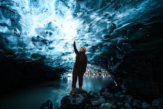 A mesmerizing view of a person exploring the vivid blue ice caves in Iceland.