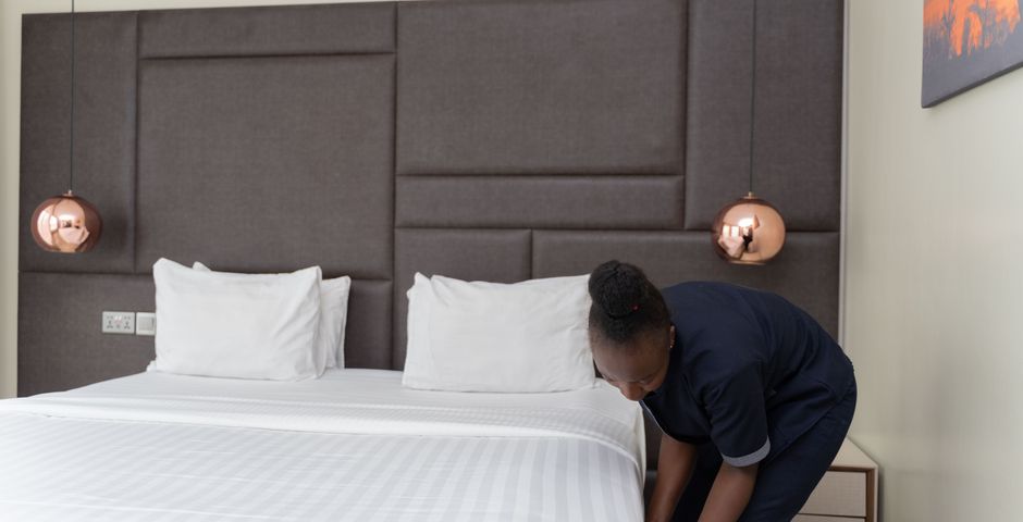 Hotel housekeeping preparing a room — treatment is scheduled discreetly between checkouts