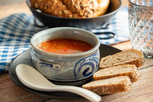 Free A traditional Russian soup served in a ceramic bowl with bread slices. Stock Photo