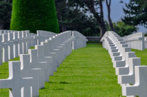 Free Rows of white crosses in a serene military cemetery honoring WWII soldiers in Normandy, France. Stock Photo
