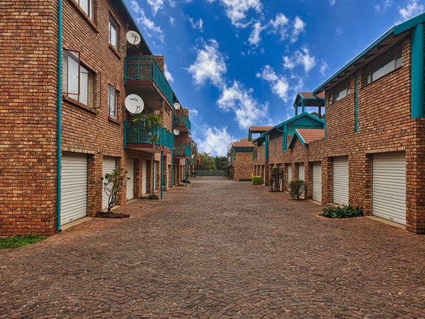 Brick rental apartment complex with tenant garages, a tenant-occupied property a landlord could sell