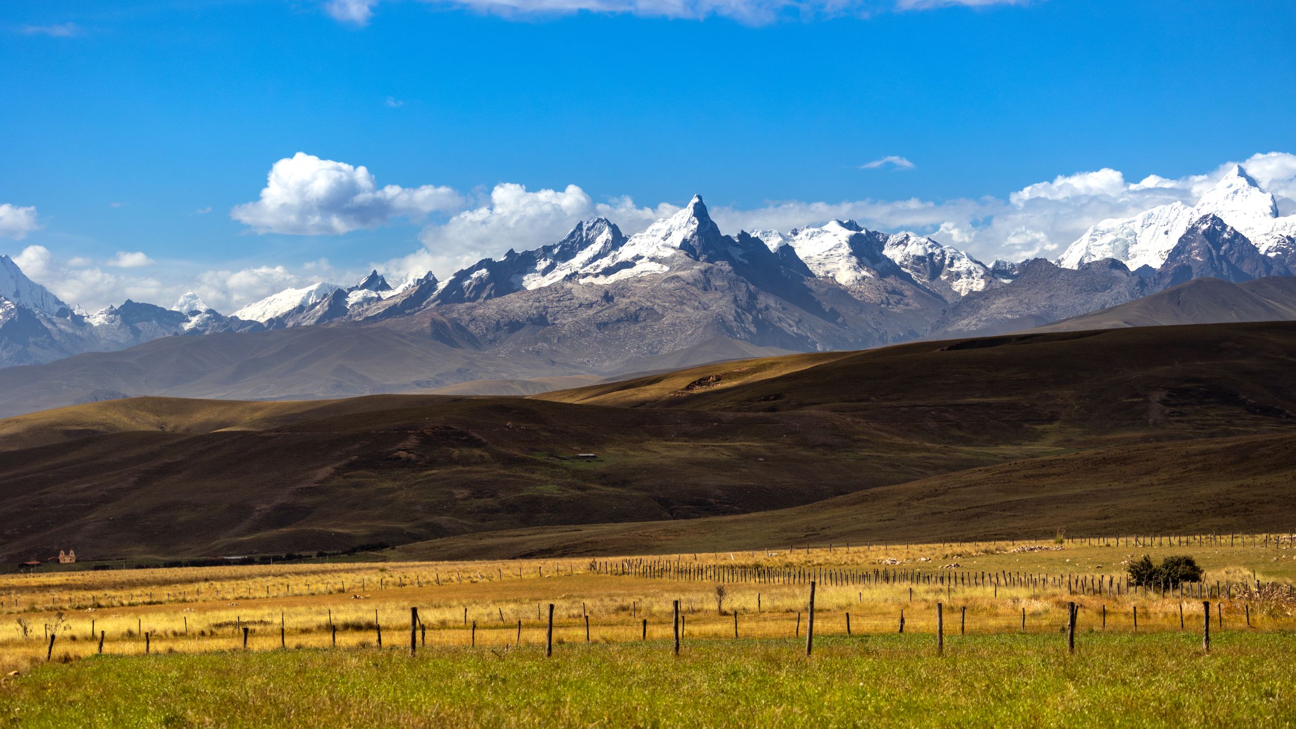 Majestic view of the Cordillera Blanca mountains against a clear blue sky in Ancash, Peru.