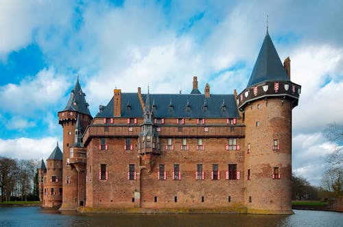 Brown and Black Castle Surrounded by Body of Water