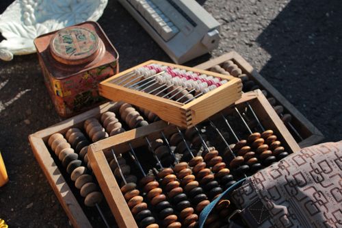 Free Collection of vintage abacuses and retro items on a sunlit surface. Stock Photo