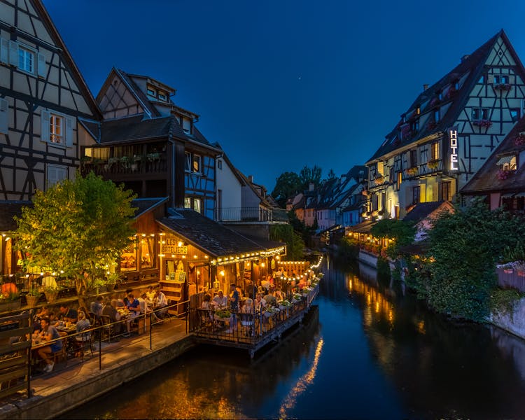 Photography Of Buildings And Canal During Nighttime