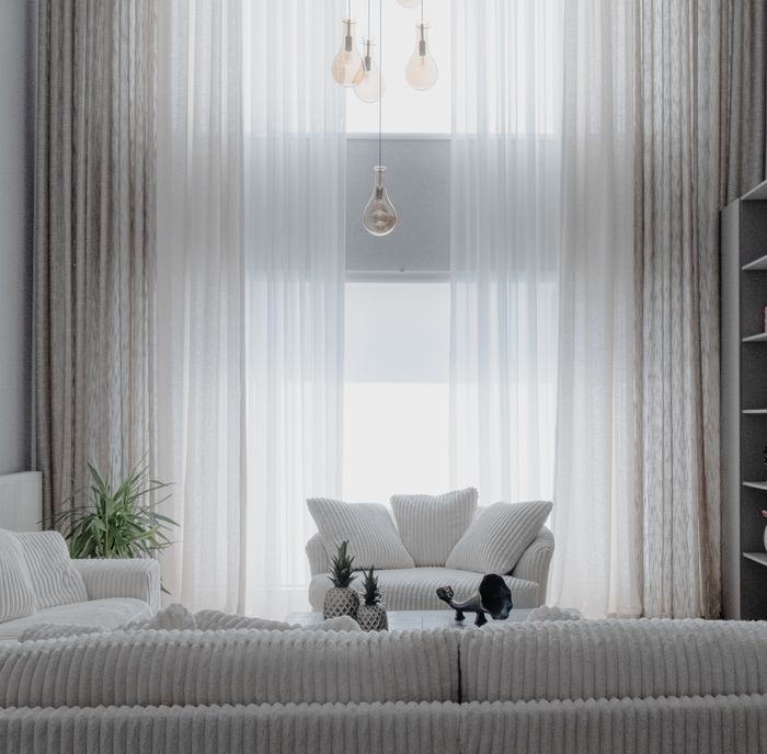 Bright living room with sheer curtains and ribbed sofas, by Beyza Kılıçdere on Pexels