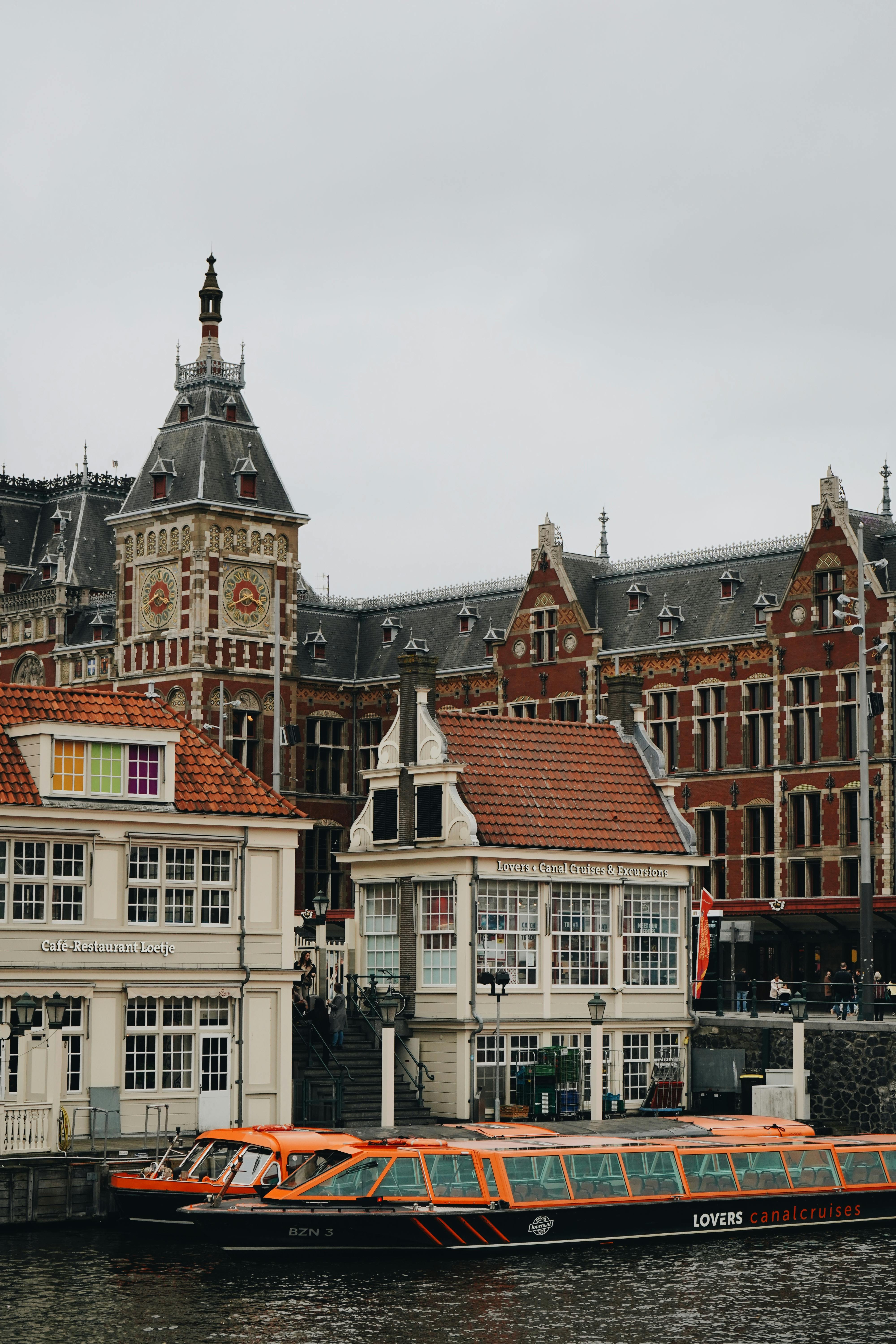 Charming canal view with historic Amsterdam architecture and canal cruise boat.