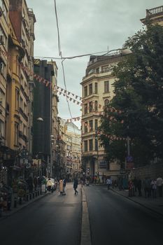 Atmospheric view of a bustling street in Istanbul with historic buildings and street decorations.