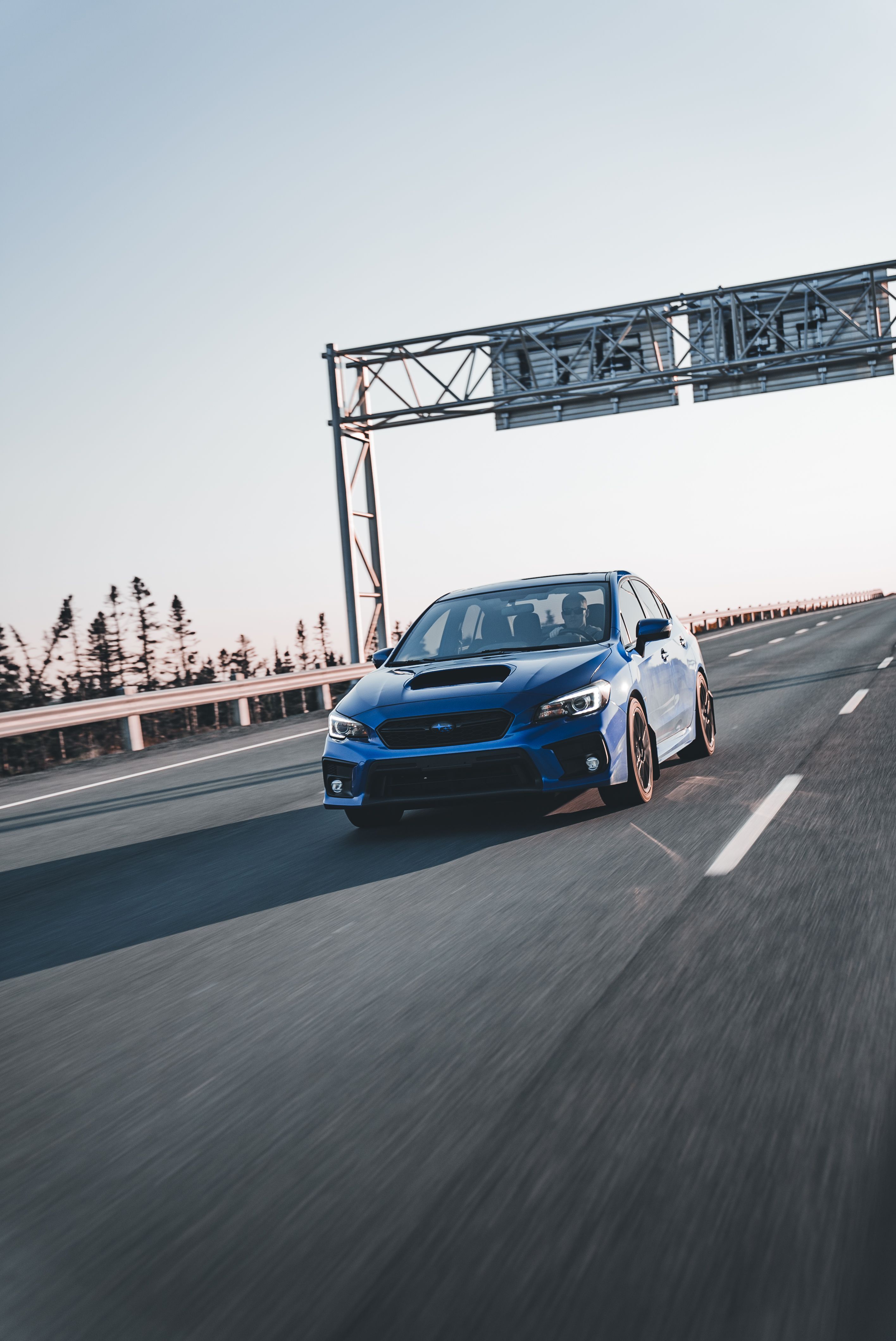 Blue Sports Car Driving Down Open Highway · Free Stock Photo