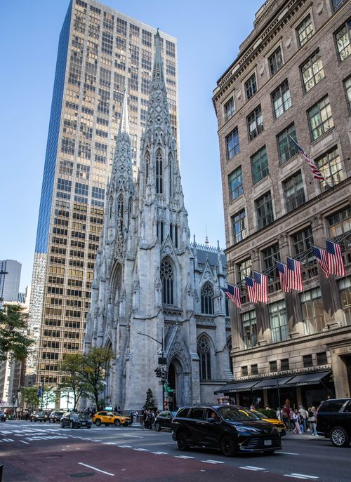 Free Majestic view of St. Patrick's Cathedral in New York City with skyscrapers in the background. Stock Photo