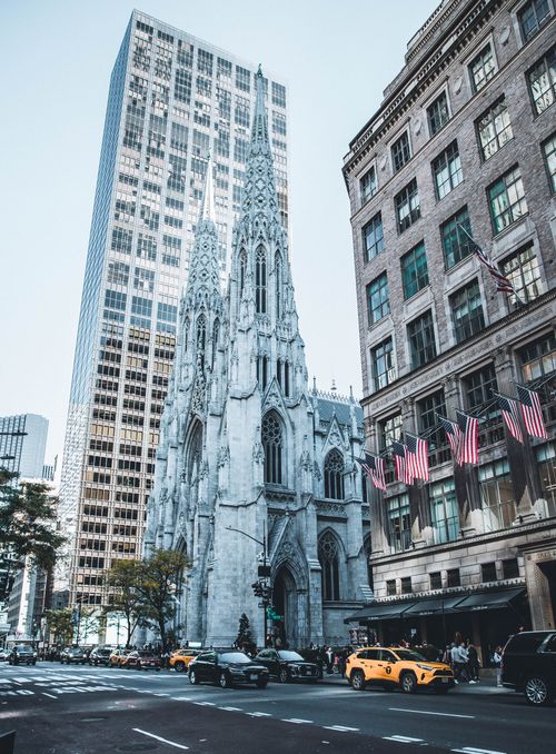 Free Iconic view of St. Patrick's Cathedral surrounded by skyscrapers in NYC. Stock Photo