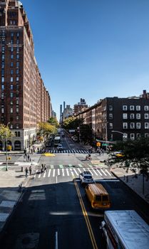 Busy New York City street view featuring iconic yellow taxis and pedestrians crossing.