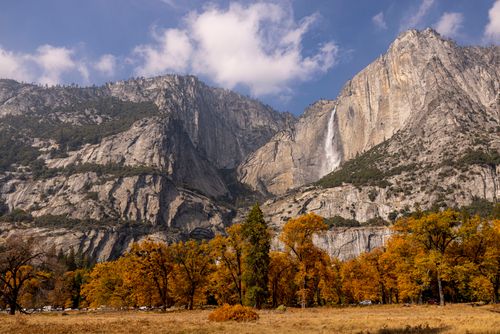 Free Breathtaking autumn landscape of Yosemite Falls with vibrant foliage and towering granite cliffs. Stock Photo
