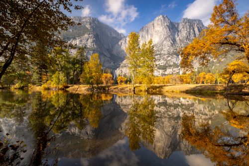 Free Stunning autumn view with fall foliage reflecting in the river at Yosemite National Park. Stock Photo