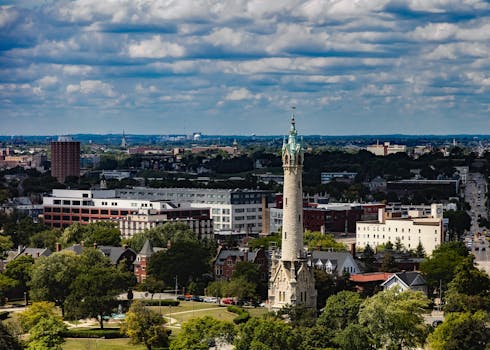 Aerial view of Milwaukee skyline featuring the historic North Point Water Tower under a cloudy sky. by Pixabay