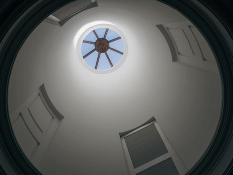 A modern dome skylight featuring architectural curves and natural light.