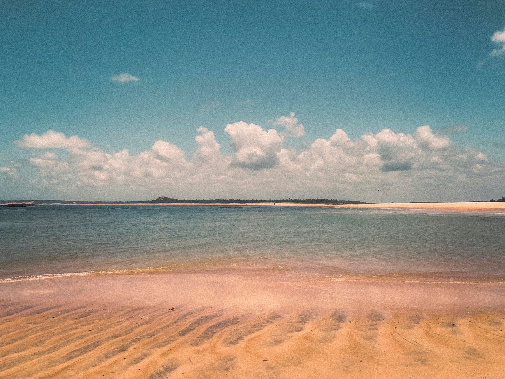 Vibrant coastal view of Barra do Cunhaú beach, capturing natural beauty under a summer sky.