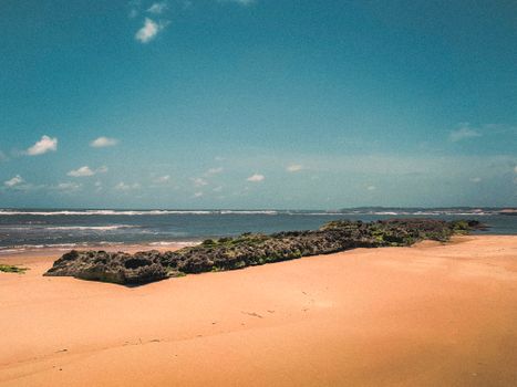 Discover the tranquil beauty of Barra do Cunhaú beach with clear skies and pristine sand.
