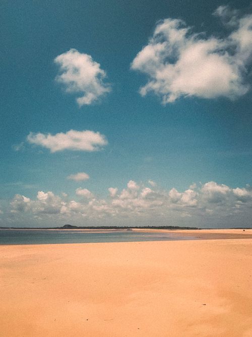 Free Sunny beach view at Barra do Cunhaú, Rio Grande do Norte. Natural beauty under clear skies. Stock Photo