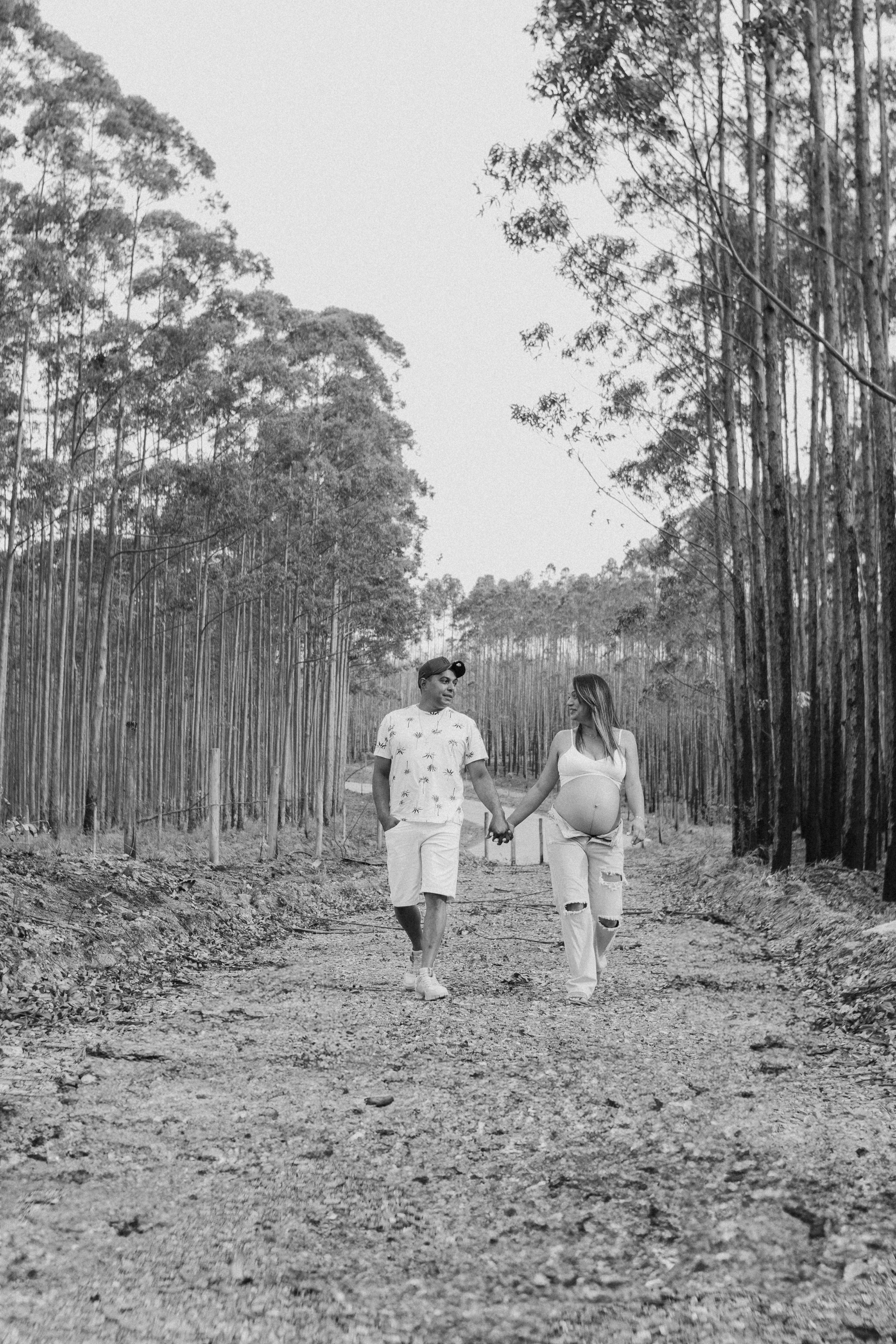 Black and White Couple Walking Through Forest Path · Free Stock Photo