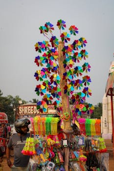 Bright pinwheels and toys on display at a bustling fair in Odisha, India.