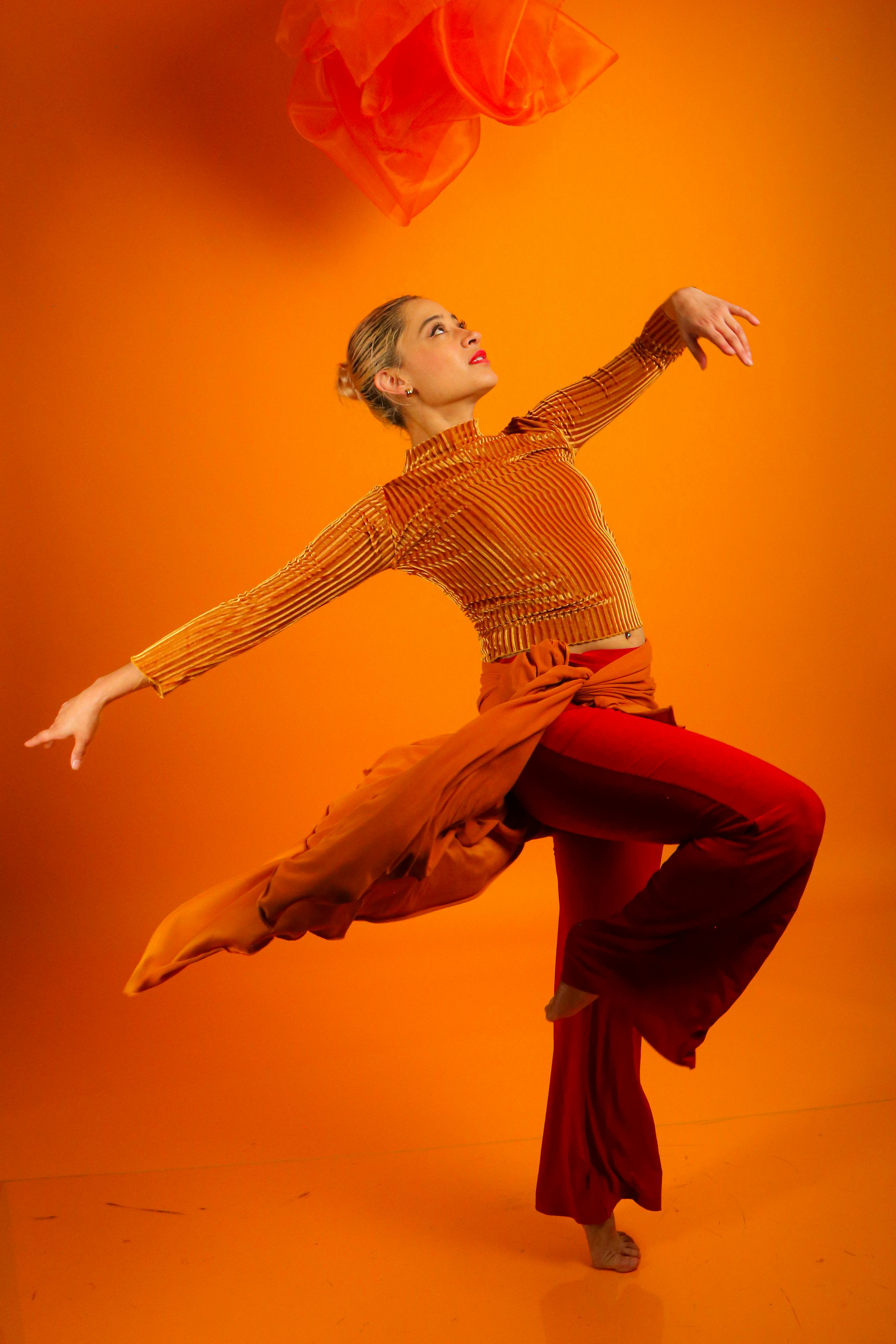 Expressive Modern Dance in Vibrant Orange Studio · Free Stock Photo