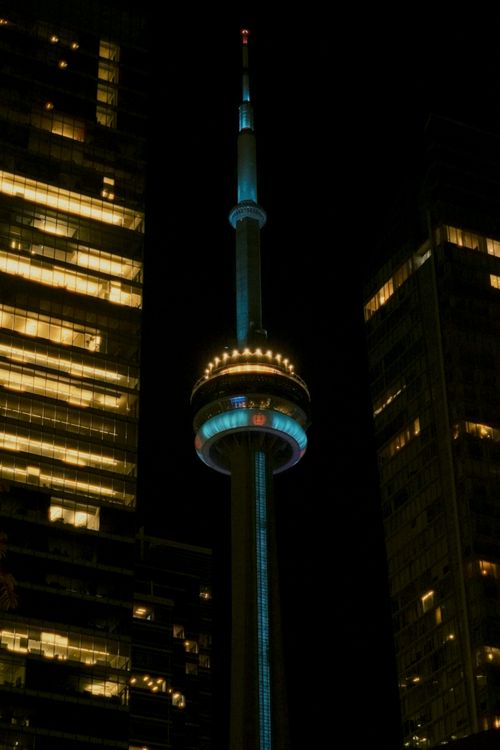 Free A stunning nighttime view of Toronto's CN Tower blending with the city's skyline lights. Stock Photo