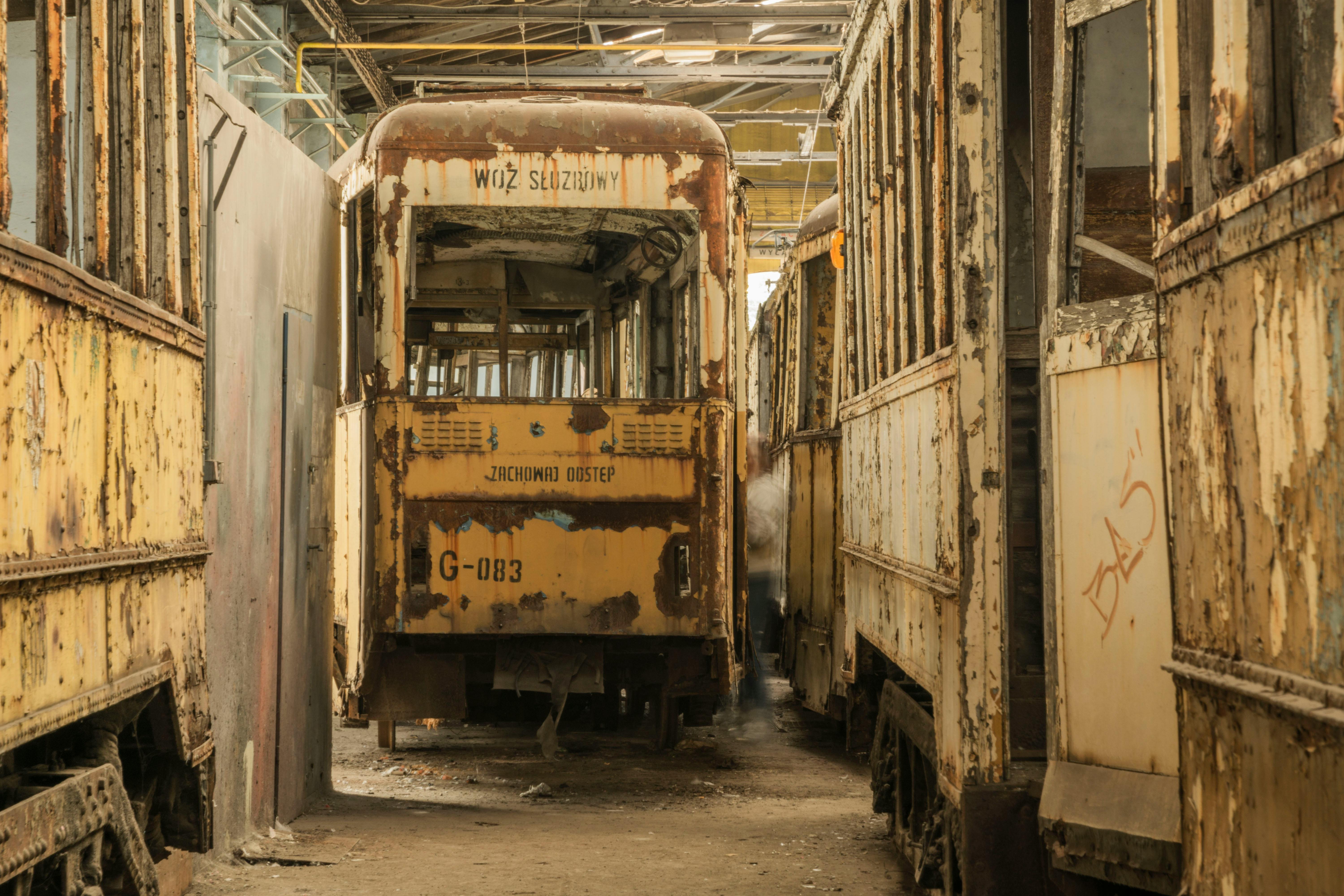 Rusty and derelict trams in an abandoned depot in Wroclaw, Poland.