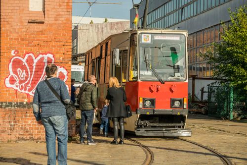 Free Group of adults and children boarding a tram in Wrocław, showcasing urban transportation. Stock Photo