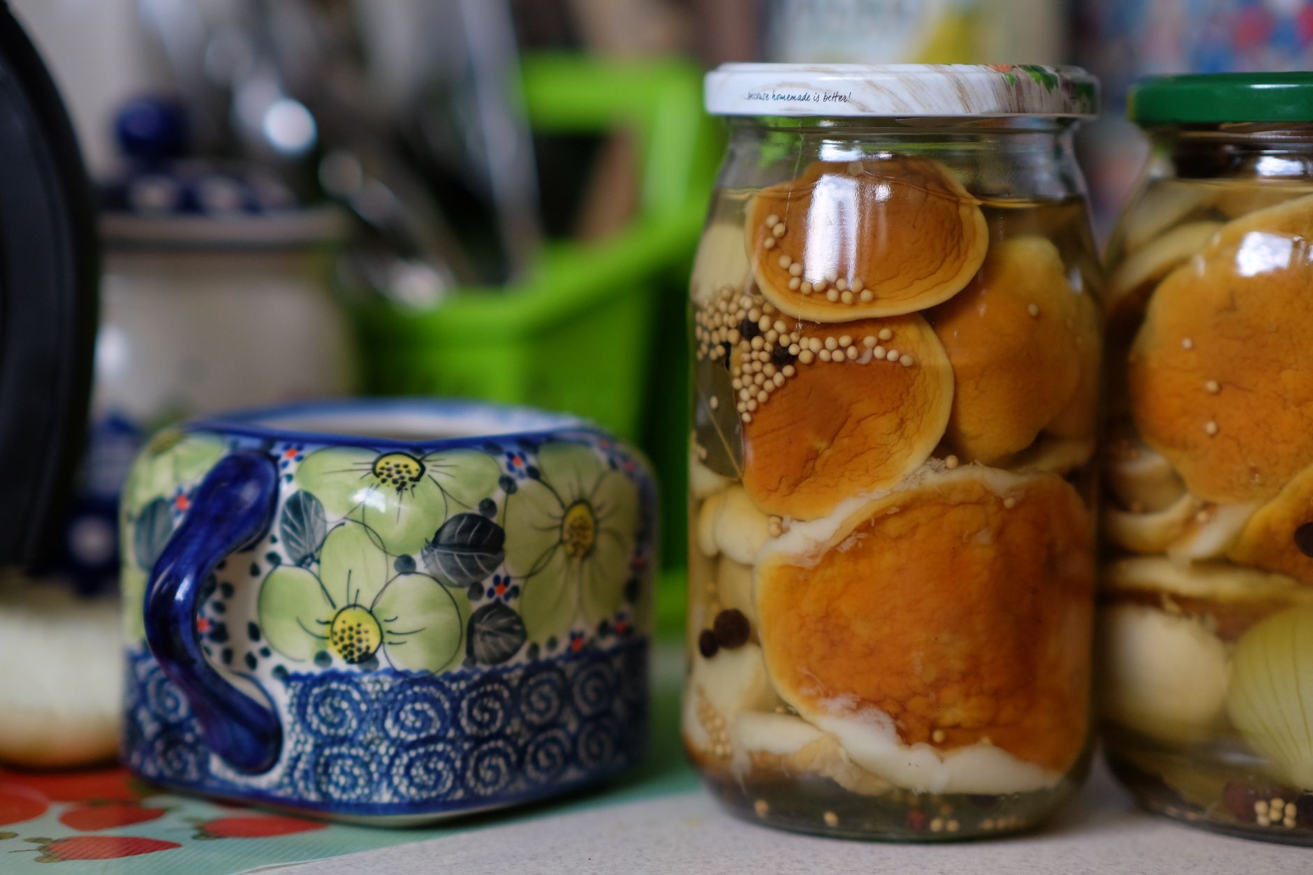Slices of bologna inside glass jar being pickled with spices