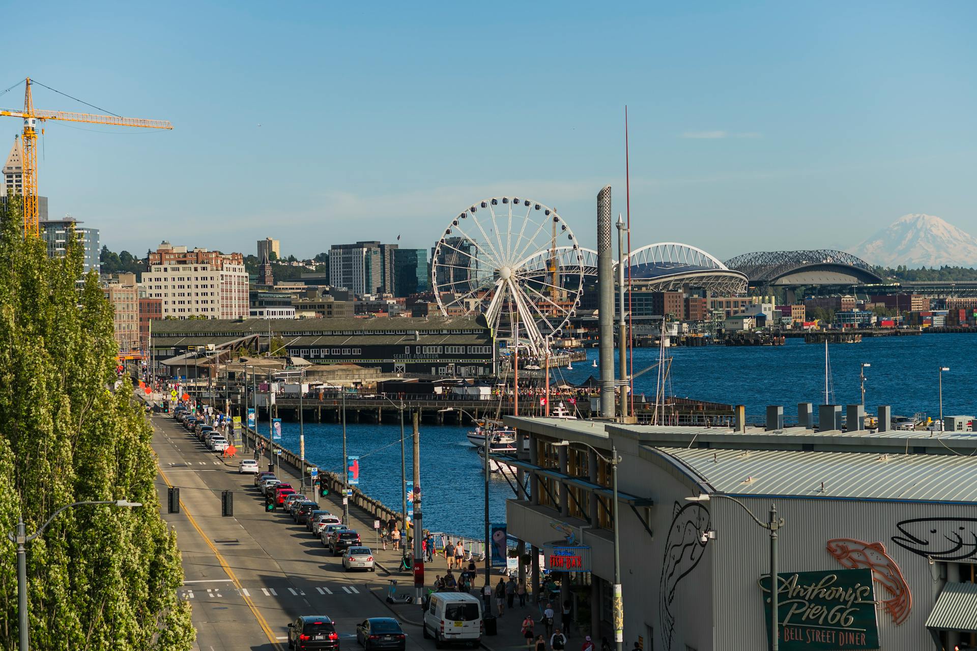 A vibrant view of Seattle's waterfront featuring the Great Wheel and city skyline.