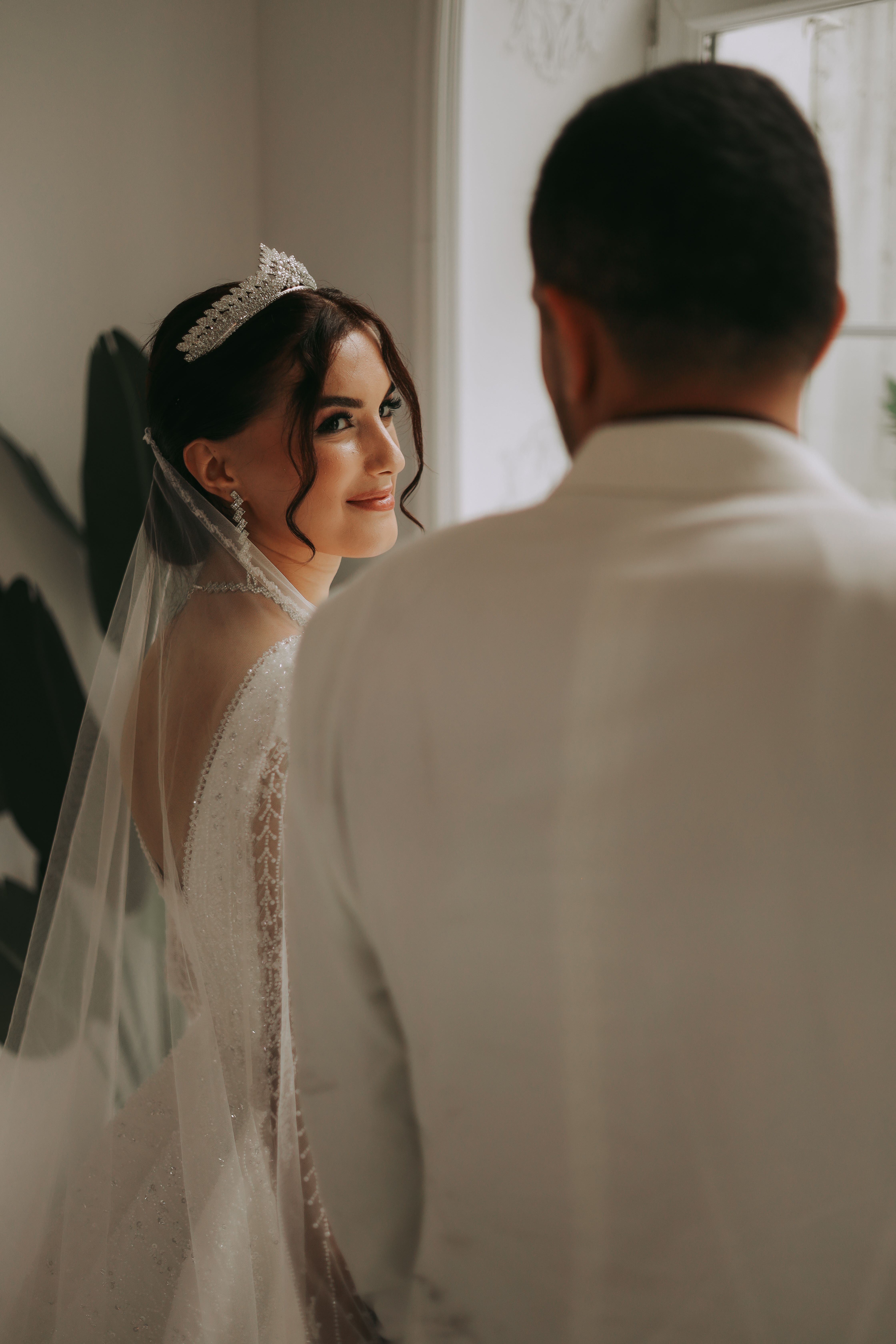 A bride and groom share a moment in an elegant wedding scene in Istanbul, Türkiye.