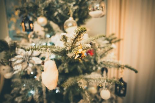 Free Festive Christmas tree with ornaments and soft lighting, creating a warm holiday atmosphere. Stock Photo