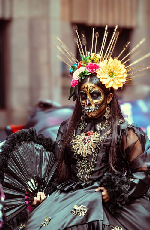 Free A beautifully adorned Catrina costume with floral headpiece in a Day of the Dead celebration. Stock Photo